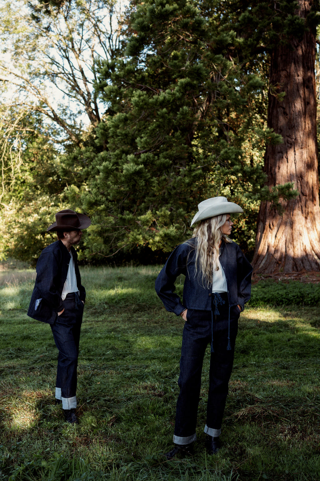 Man and woman in double selvedge denim under the trees