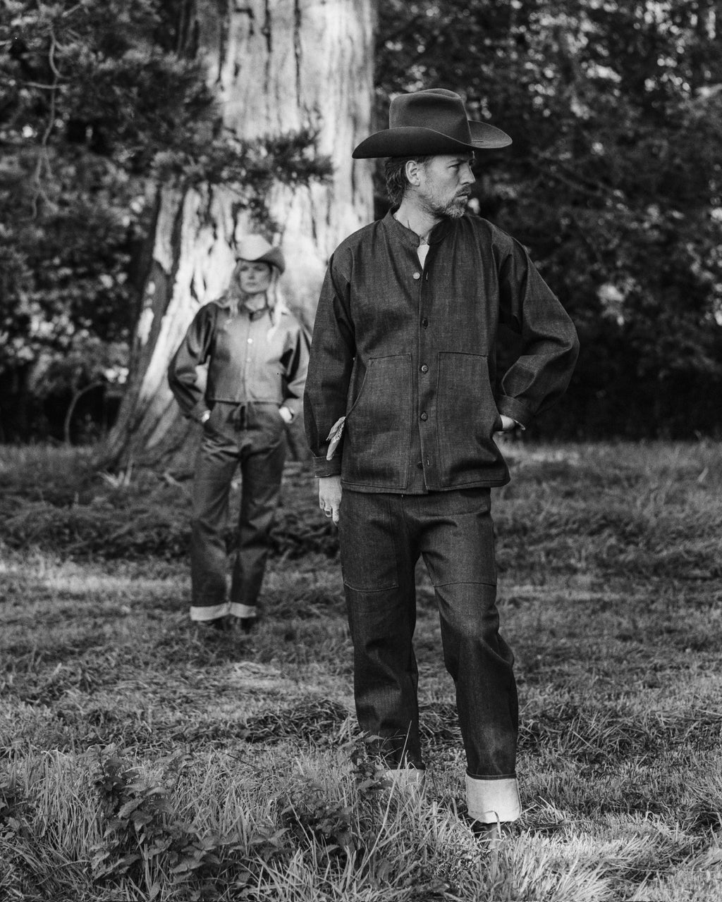 Man and woman in double selvedge denim under the trees
